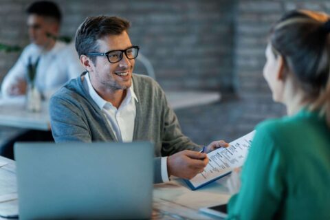 Happy businessman talking with his colleague