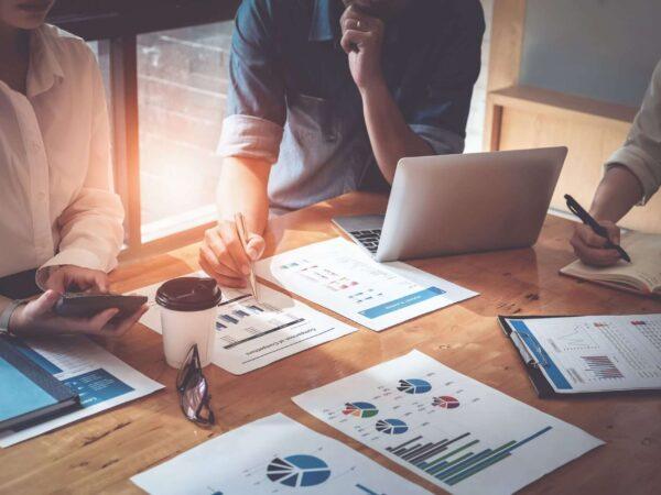 people at a desk working on reports