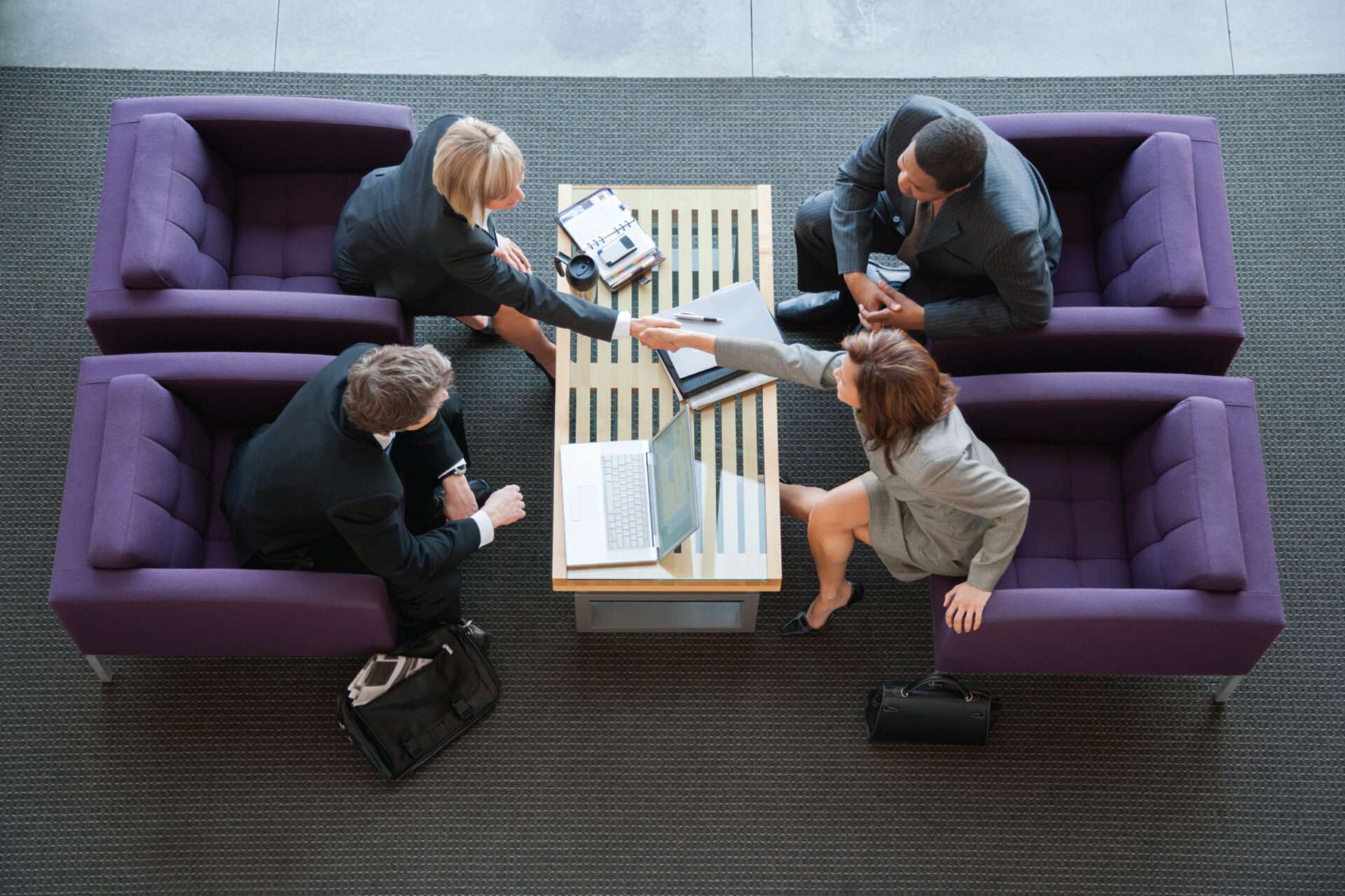 Four office workers sitting in chairs